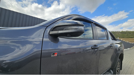 Bed liner, roll cover, rollbar, cross bars, window visors installed on Hilux GR Sport